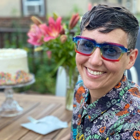 photo of customer wearing a dark floral shirt with rainbow pride limited edition l.a.eyeworks fashion glasses | eyedeals eyewear