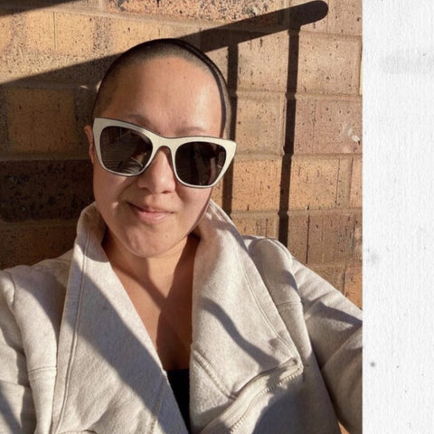 photo of customer in an ivory sweatshirt wearing oversized white square sunglasses with a silver mirror | eyedeals eyewear fashion