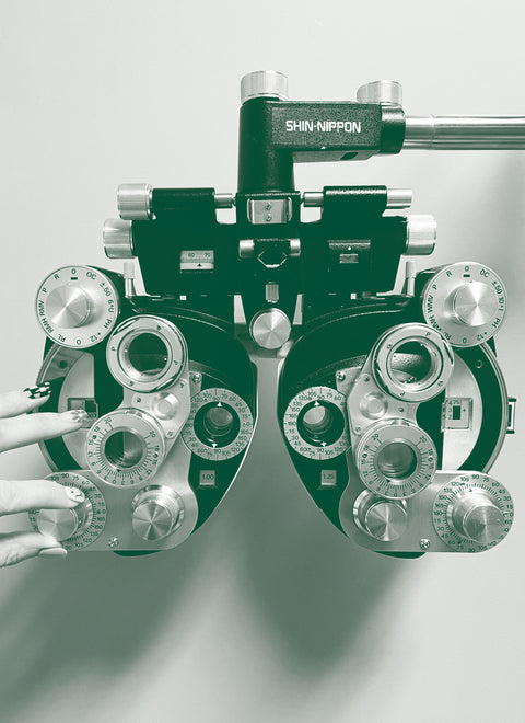 a photo of a phoropter with a hand adjusting the diopters | eyedeals eyecare
